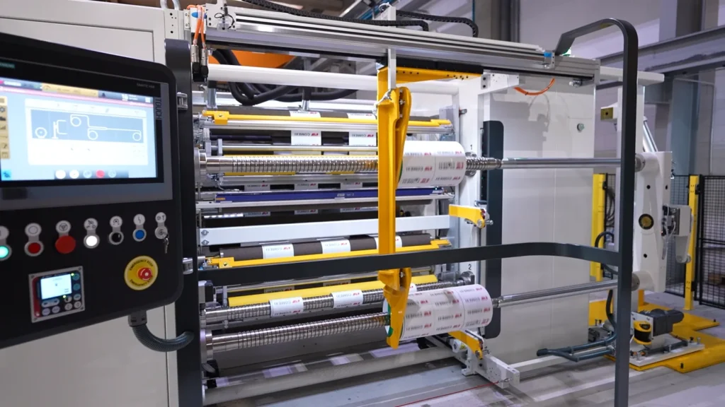 End of line automation system connected to a Comexi slitter with double turret rewinder